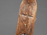 a wooden mask with a face made out of wood