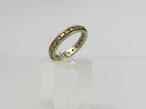a gold wedding ring with a diamond set in the middle