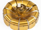an image of a gold metal object on a white surface