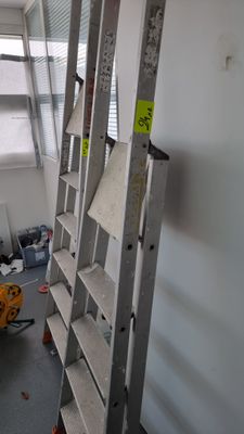 a ladder that is leaning against a wall in a room