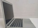 a silver laptop computer sitting on a white table