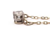 a close up of a chain with a diamond on it