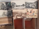 a room with a bunch of pictures on the wall and pictures on the floor