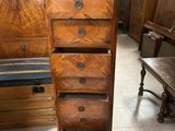 a tall wooden chest of drawers in a room