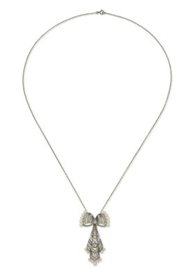 a silver necklace with a bow on a chain on a white background