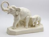 statue of an elephant with a baby elephant on a base