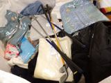 a pile of clothes and other items in a suitcase