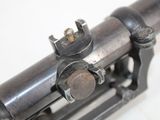 a close up of a gun on a white surface