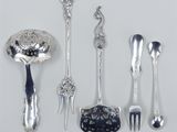 a lot of silver spoons and forks on the table