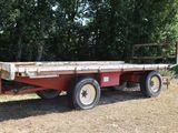 a red flat bed trailer parked in a field