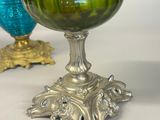 two green vases sitting next to each other on a table