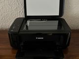 a printer sitting on top of a wooden cabinet