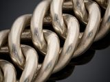 a close up of a silver chain on a black background