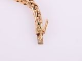 an image of a gold bracelet with a snake on it