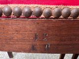 a close up of a wooden chair with a number on it