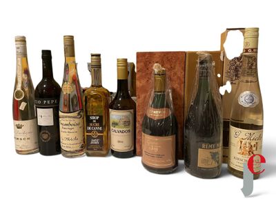 bottles of wine are lined up in a row on a white surface