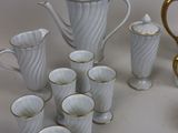 a lot of cups and a teapot on the table