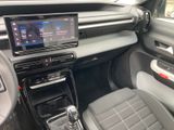the interior of a car with a touch screen and a steering control