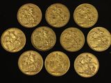 six gold sovereigns of various sizes and shapes on a black surface
