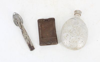 a small bottle and a spoon next to a wallet