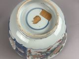 a white vase with a blue and white design on it