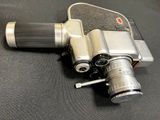 a silver camera sitting on top of a black table