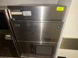 a stainless steel refrigerator in the corner of a room