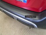 a close up of a red car with a license plate on it