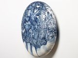 a blue and white stone with a tree on it