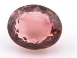 a close up of a pink quartz stone on a white surface