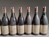 six bottles of wine are lined up in a row on a table