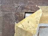a picture of a piece of wood with a piece of paper sticking out of it