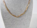 a gold necklace on a mannequin mannequin display