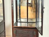 a display case with a glass door in the middle of a room