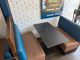 a bench and a table in the corner of a restaurant