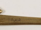an old axe that is laying on a white surface