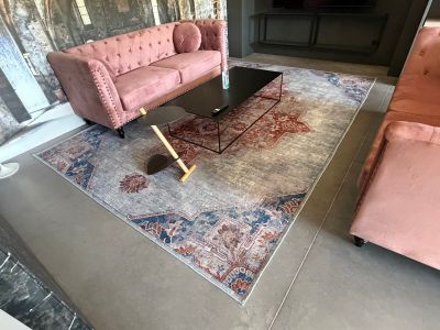 a pink couch and a pink chair in a living room