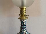 a lamp that is sitting on a table in front of a mirror