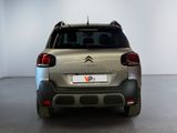 the rear end of a silver citrole parked in a white room