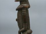 an old wooden statue of a man with a headdress