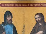 an image of a painting of two men with a cross in their hands