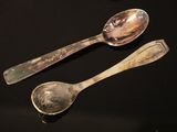 two spoons that are sitting on a table