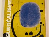 une image représentant un livre sur lequel figure un cercle bleu