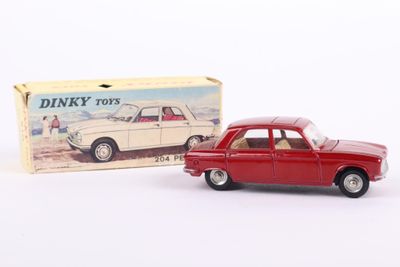 toy car in front of a boxed box of dinky toys