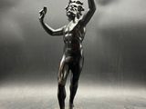 statue of a man with a fist in his hand on a pedestal