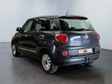 the back end of a small black car parked in a room