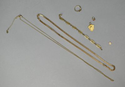 several gold necklaces and bracelets laid out on a table