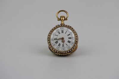 une montre de poche ancienne en or avec des chiffres romains sur le cadran