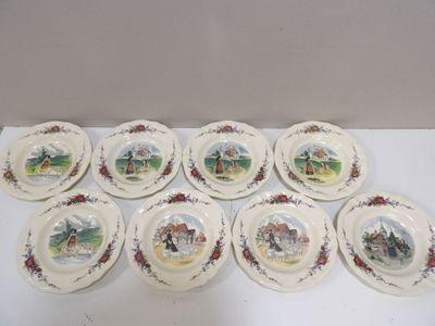 six plates with a picture of a farm scene on them on a table
