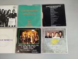 four cd ' s of various albums, including one with a picture of a group of people